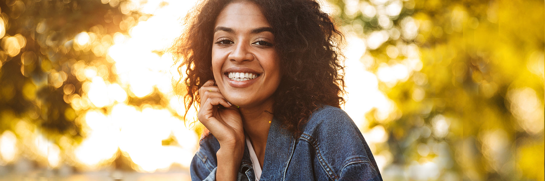 Woman wearing denim jacket outdoors in fall