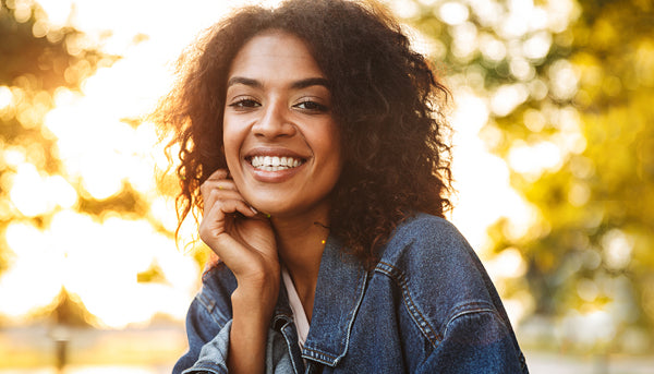 Woman wearing denim jacket outdoors in fall