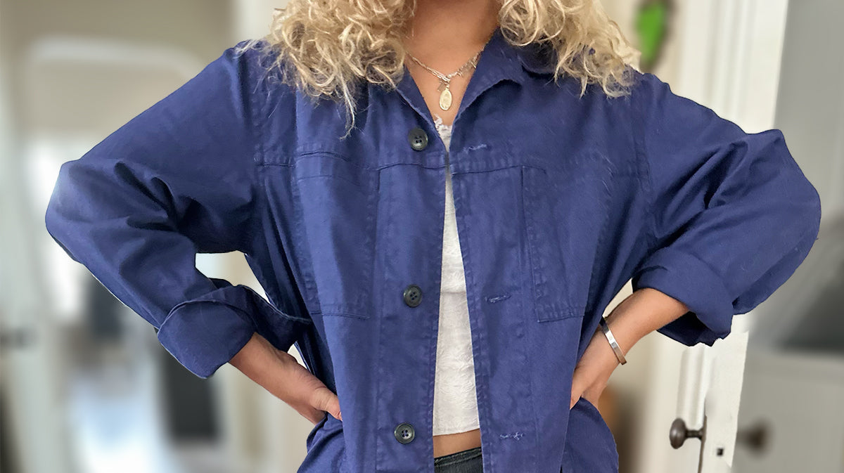 Photo of woman wearing a blue work jacket.